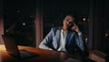 Depressed company worker sitting office at night close up. Sleepy girl laptop Royalty Free Stock Photo
