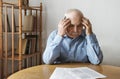 Depressed, concerned senior man doing paperwork Royalty Free Stock Photo