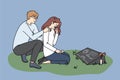 Sad couple crying at pet gravestone