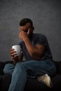 depressed crying man holding cup of coffee sitting Royalty Free Stock Photo