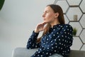 Depressed and dejected woman sitting on the sofa in the house