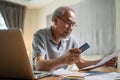 Depressed desperate Asian Senior Elderly male feeling worried about financial problem. Stressed older man looking frustrated to Royalty Free Stock Photo