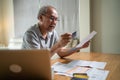 Depressed desperate Asian Senior Elderly male feeling worried about financial problem. Stressed older man looking frustrated to pa Royalty Free Stock Photo