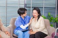 Depressed elderly female crying, young nurse consoling her at retirement home. Unhappy impaired man feeling lonely and sad Royalty Free Stock Photo