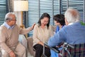 Depressed elderly female crying, young nurse consoling her at retirement home. Unhappy impaired man feeling lonely and sad Royalty Free Stock Photo