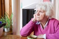 Depressed elderly woman sitting at the table Royalty Free Stock Photo