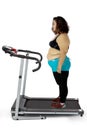 Depressed fat woman standing on the treadmill