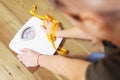 Depressed, frustrated and sad woman with a measuring tape looks at a white scale on a wooden floor Royalty Free Stock Photo