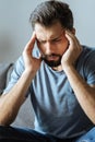 Depressed good looking man holding his temples Royalty Free Stock Photo