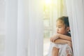 Depressed Little girl near window at home, closeup Royalty Free Stock Photo