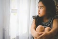 Depressed Little girl near window at home, closeup Royalty Free Stock Photo