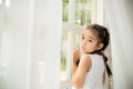 Depressed Little girl near window at home Royalty Free Stock Photo