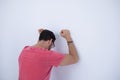 Depressed male executive with arms raised leaning on wall Royalty Free Stock Photo