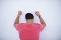Depressed male executive with arms raised leaning on wall Royalty Free Stock Photo