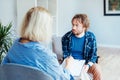 Depressed male patient having psychotherapy session with counselor at mental health clinic. Man with emotional problems Royalty Free Stock Photo