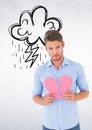 Depressed man holding broken heart against white background Royalty Free Stock Photo