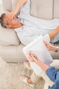 Depressed man lying on couch and talking to therapist Royalty Free Stock Photo