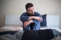 Man feeling bad and seated on the bed Royalty Free Stock Photo