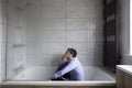 Depressed man sitting in bath Royalty Free Stock Photo