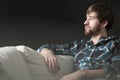 Depressed man is sitting on couch Royalty Free Stock Photo