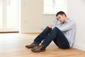 Depressed Man Sitting In Empty Room Of Repossessed House Royalty Free Stock Photo