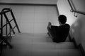 Depressed man sitting on stair of residence building. Sad man, Cry, drama, lonely and unhappy concept