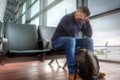 Depressed man waiting for the delayed plane Royalty Free Stock Photo