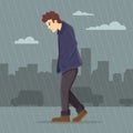 Depressed man walking in the rain