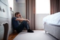 Depressed Man Wearing Pajamas Sitting On Floor Of Bedroom Royalty Free Stock Photo