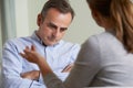 Depressed Mature Man Talking To Counsellor