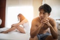 man sitting on the bed in bedroom have problem with his wife