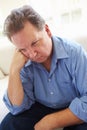 Depressed Overweight Man Sitting On Sofa Royalty Free Stock Photo