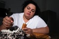 Depressed overweight woman eating sweets in kitchen Royalty Free Stock Photo