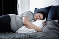 Depressed overweight woman lying alone on bed. Autophobia Royalty Free Stock Photo