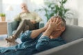 Depressed patient lying on the couch in the therapist`s office Royalty Free Stock Photo