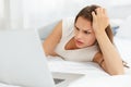 Depressed Pregnant Woman Works at Laptop Computer While Lying on Royalty Free Stock Photo