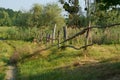 Depressed region. Dilapidation of the village. An unkempt old fence and outskirts. View of outskirts and pole fence in