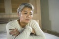 Depressed and sad grey hair mature woman crying lonely sitting on bed suffering crisis in pain and depression problem feeling lost Royalty Free Stock Photo