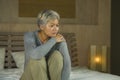 Depressed and sad grey hair mature woman crying lonely sitting on bed suffering crisis in pain and depression problem feeling lost Royalty Free Stock Photo