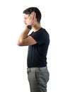 Depressed, sad or irritated young man covering ears with hands