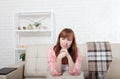 Depressed and sad middle aged woman sitting on bed, coach, sofa at home. Copy space and mock up. Royalty Free Stock Photo