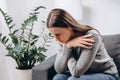 Depressed sad young female sitting on couch in living room, expression to face difficulty, failure and exhausted. Worried upset Royalty Free Stock Photo