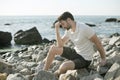 Depressed sad young man sitting on a sea beach Royalty Free Stock Photo