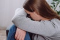 Depressed sad young woman sitting on sofa in living room, expression to face difficulty, failure and exhausted. Worried upset Royalty Free Stock Photo