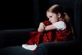 Depressed, scared child sitting in armchair