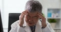 Senior asian doctor feel tired Royalty Free Stock Photo