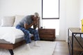 Depressed Senior Man Looking Unhappy Sitting On Side Of Bed At Home With Head In Hands Royalty Free Stock Photo