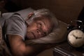 Depressed senior man lying in bed cannot sleep from insomnia Royalty Free Stock Photo