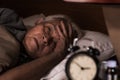 Depressed senior man lying in bed cannot sleep from insomnia Royalty Free Stock Photo