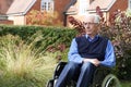 Depressed Senior Man Sitting Outdoors In Wheelchair Royalty Free Stock Photo